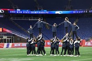 Needham cheeleaders perform at Gillette Stadium during D-I football state championship